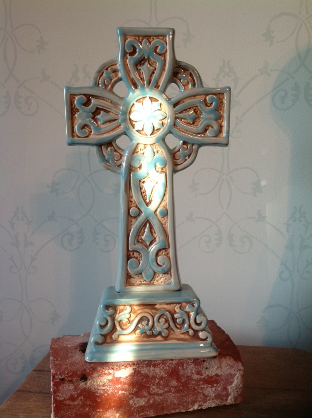  A friend gave me this cross and an old classmate gave me the brick from our old high school, which sits on top of my grandad's tobacco stand, with pale aqua stencilled walls in the background. :)